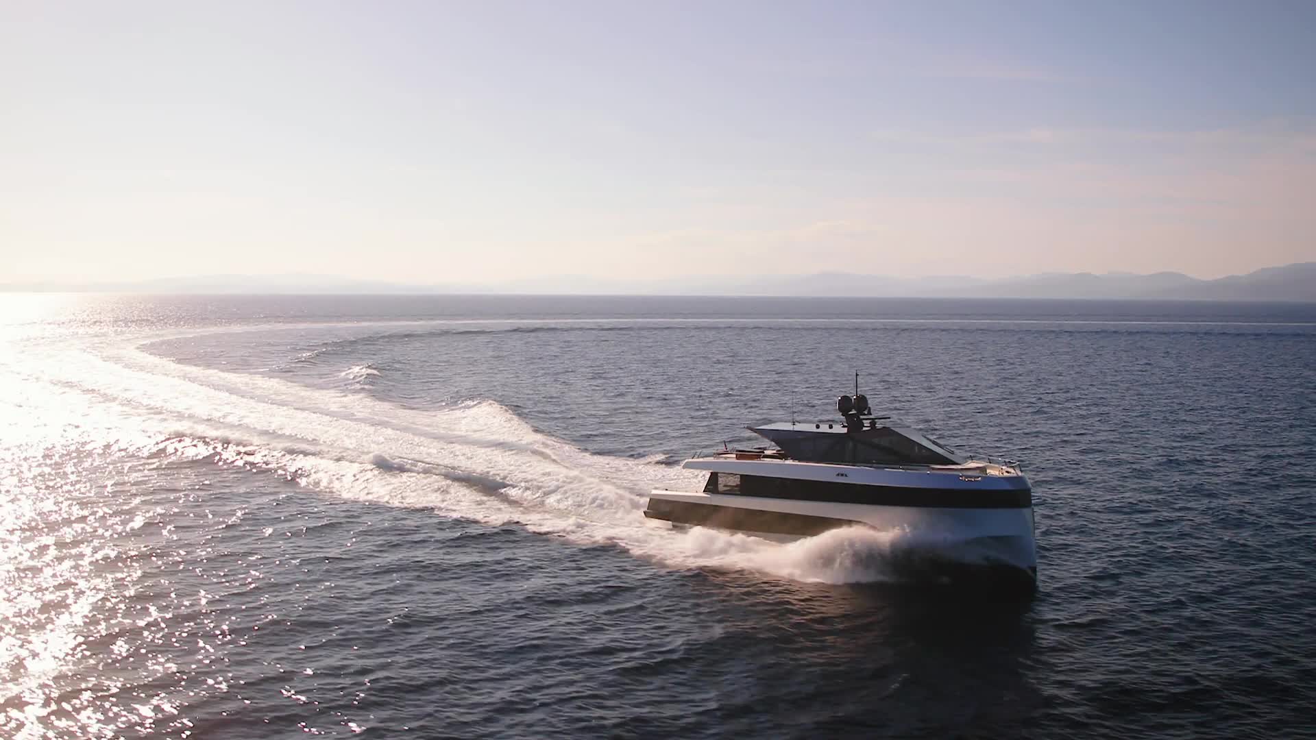 Luxury yacht at speed on open water, Miami skyline in the distance